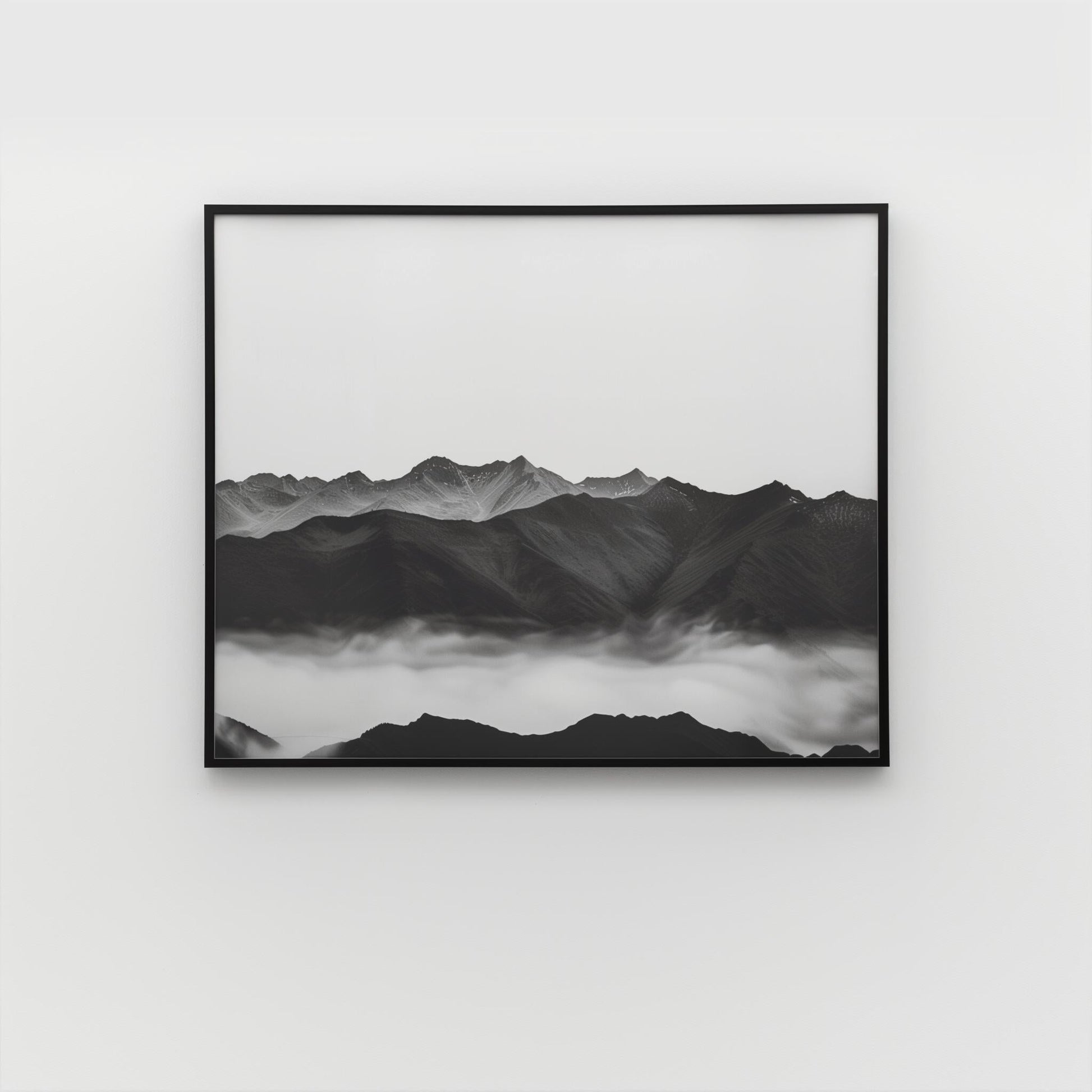 Framed grayscale landscape wall art with mountain peaks and fog, black frame